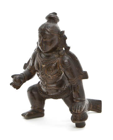 An Indian Bronze Figure of Krishna, Height 4 1/2 i: An Indian Bronze Figure of Krishna, depicted in a striding pose wearing elaborate armor holding a ball in his right hand. Height 4 1/2 inches. Property from a Private Collector Boca Raton, Florida