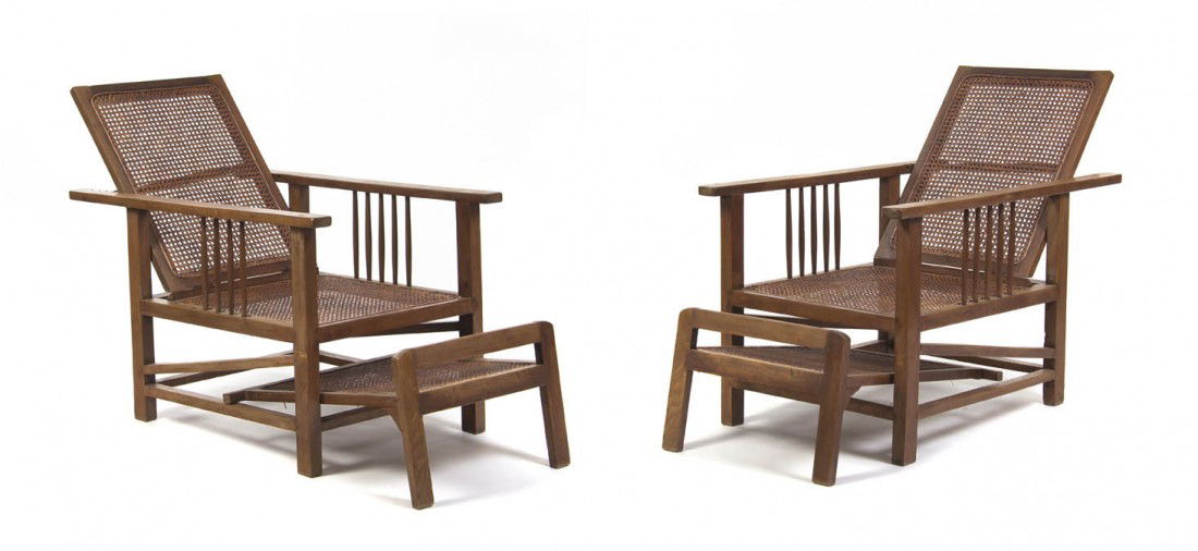 A Pair of American Oak Morris Chairs, Height 39 x: A Pair of American Oak Morris Chairs, each having a caned back, seat and pullout footrest within squared supports. Height 39 x width 25 x depth 40 inches.