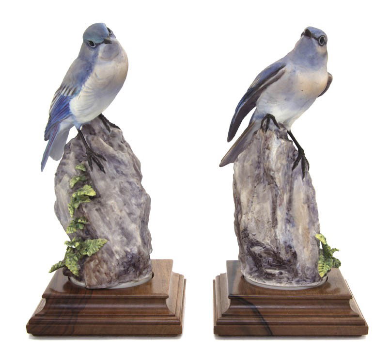 A Pair of Royal Worcester Dorothy Doughty Birds, : A Pair of Royal Worcester Dorothy Doughty Birds, Mountain Bluebirds, each perched on a rocky formation with ferns. Height of taller 9 1/4 inches.