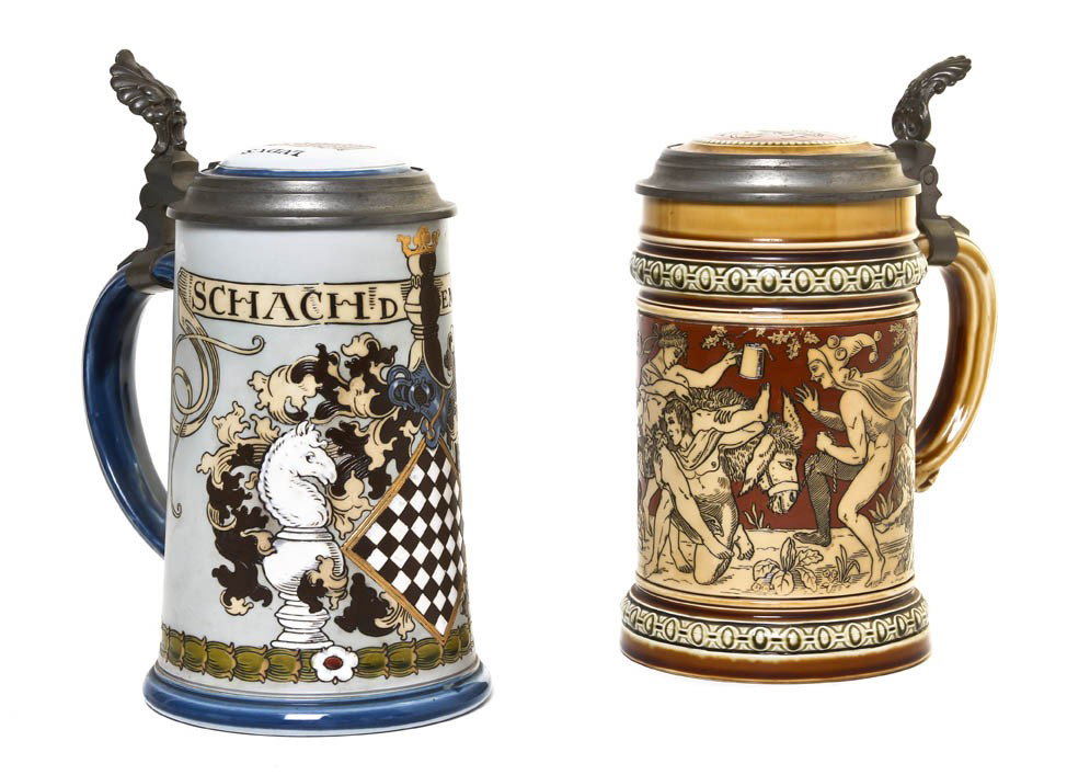 Two Mettlach Half-Liter Ceramic Steins, Height of: Two Mettlach Half-Liter Ceramic Steins, each having a ceramic inset pewter lid, one numbered 2035 and decorated with a Bacchanalian scene, the other numbered 2049, decorated with chess pieces and havi