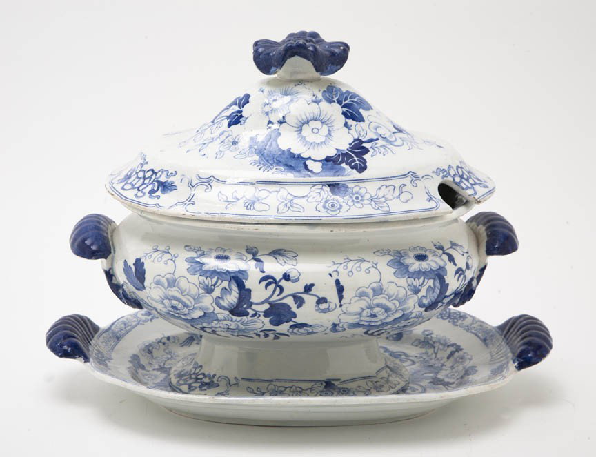 An English Ironstone Tureen and Tray, Width of tr: An English Ironstone Tureen and Tray, having a floriform finial and shell form handles, with floral transfer decoration throughout. Width of tray 13 inches.