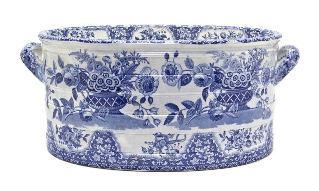 A Spode Ceramic Basin, Width over handles 18 5/8: A Spode Ceramic Basin, of handled oval form with transfer decoration depicting urns issuing flowers. Width over handles 18 5/8 inches.