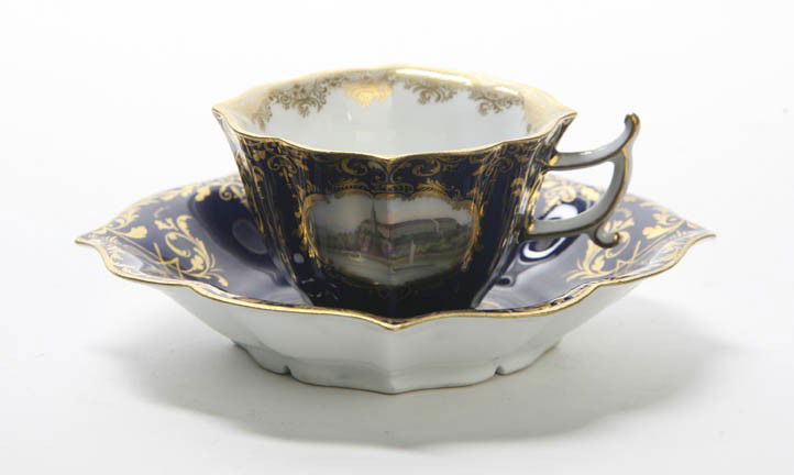 A Meissen Cup and Saucer, Diameter of saucer 5 1/: A Meissen Cup and Saucer, each with gilt and polychrome floral decoration on a cobalt ground, having crossed swords mark in underglaze blue. Diameter of saucer 5 1/2 inches. Property from the Estate o