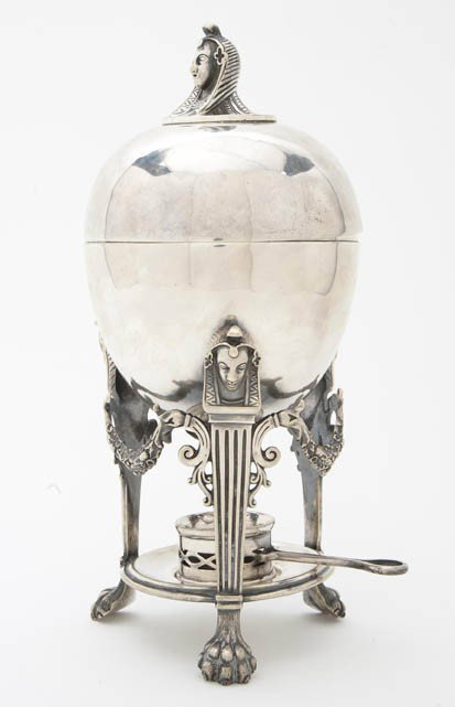 A English Silverplate Egyptian Revival Egg Coddle: A English Silverplate Egyptian Revival Egg Coddler, Atkins Bros., Sheffield, having a Pharoah finial above the ovoid case raised on three fluted supports with mask capitals joined by garlands and endi