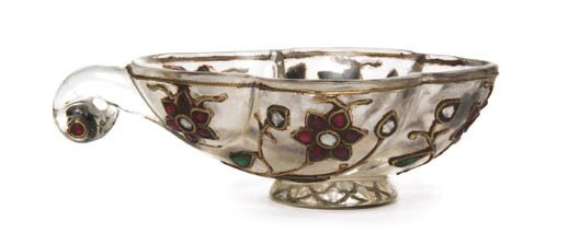 A Mughal Rock Crystal Coupe, Width overall 3 3/8 : A Mughal Rock Crystal Coupe, of lobed form having applied gilt and stone floral decoration, having a bird form scrolled handle with inlaid eyes, raised on a circular foot. Width overall 3 3/8 inches.