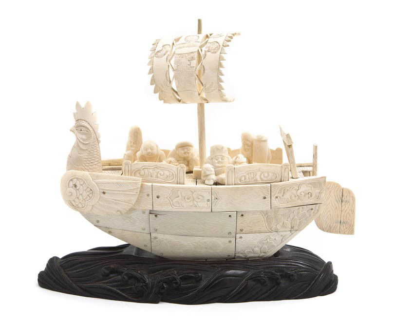 A Chinese Ivory Chicken Boat, Width 10 1/2 inches: A Chinese Ivory Chicken Boat, the vessel surmounted with a pierce carved sail and bearing five detachable ivory figures of sages with various attributes, the ship's body constructed from flat ivory pa