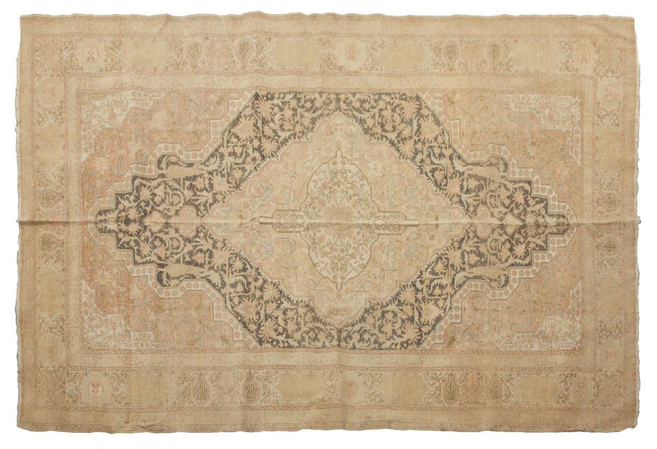 A Turkish Wool Rug, 6 feet 9 x 4 feet 8 1/2 inc: A Turkish Wool Rug, having a central ivory lozenge within an allover foliate field within triple borders. 6 feet 9 x 4 feet 8 1/2 inches.