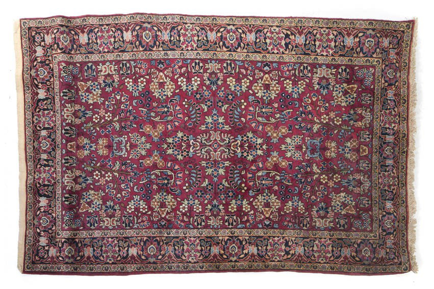 A Sarouk Wool Rug, 6 feet 7 inches x 4 feet 5 inc: A Sarouk Wool Rug, having stylized foliate center medallion on a maroon field within triple borders. 6 feet 7 inches x 4 feet 5 inches. Property from the Leon Brown Trust, U.S. Bank, Trustee, Troy, Oh