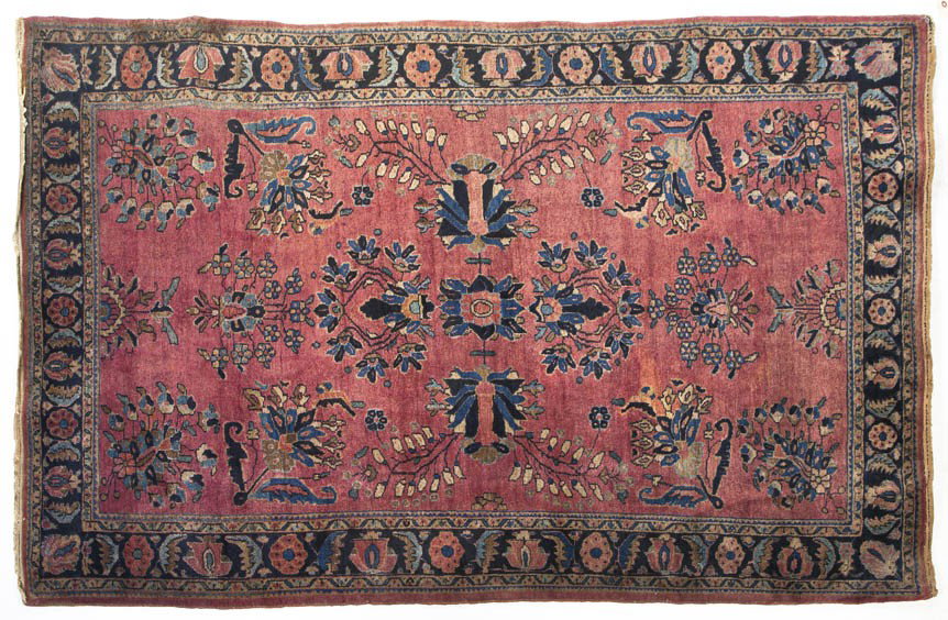 A Sarouk Wool Rug, 6 feet 5 inches x 4 feet 3 inc: A Sarouk Wool Rug, having a stylized foliate center medallion on a maroon ground within multiple borders. 6 feet 5 inches x 4 feet 3 inches. Property from the Leon Brown Trust, U.S. Bank, Trustee, Tro