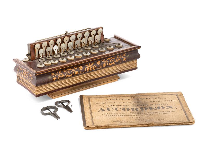 Three American Musical Instruments: Three American Musical Instruments 19th Century comprising two mouth harps and an accordion with an instructional booklet. Accordion: height 5 x length 12 1/4 x depth 4 1/2 inches. This lot