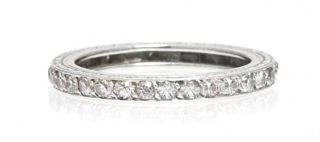 An Edwardian Platinum and Diamond Eternity Band, 1.: An Edwardian Platinum and Diamond Eternity Band, containing numerous old European cut diamonds weighing approximately 0.70 carat total, engraved gallery. 1.80 dwts. Property from the Estate of Helen R