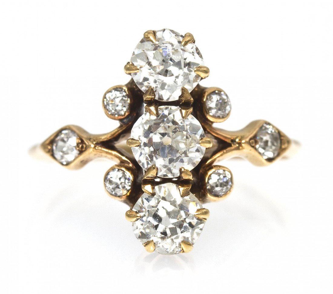 An Edwardian Yellow Gold and Diamond Ring, 1.60 dwt: An Edwardian Yellow Gold and Diamond Ring, containing 9 old European cut diamonds weighing approximately 1.13 carats total set in an openwork setting. 1.60 dwts. Property from the Collection of Judi F