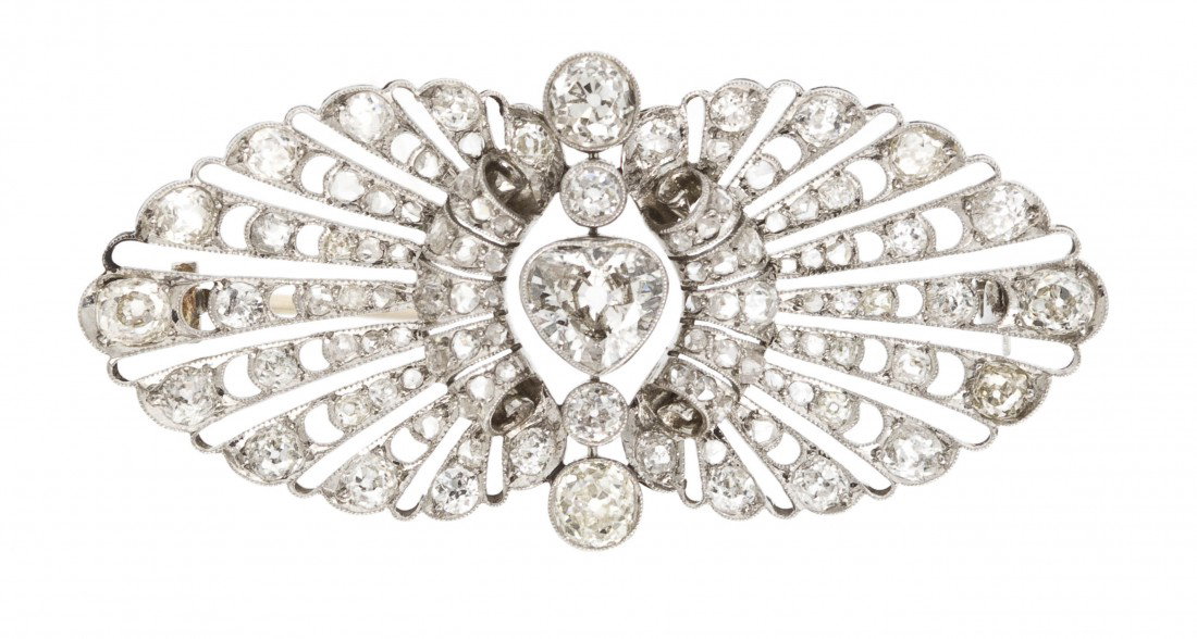 An Edwardian Platinum and Diamond Brooch, 10.20 dwt: An Edwardian Platinum and Diamond Brooch, containing one heart shape antique cut diamond weighing approximately 1.10 carats, two old mine cut diamonds weighing approximately 1.00 carat total, and nume