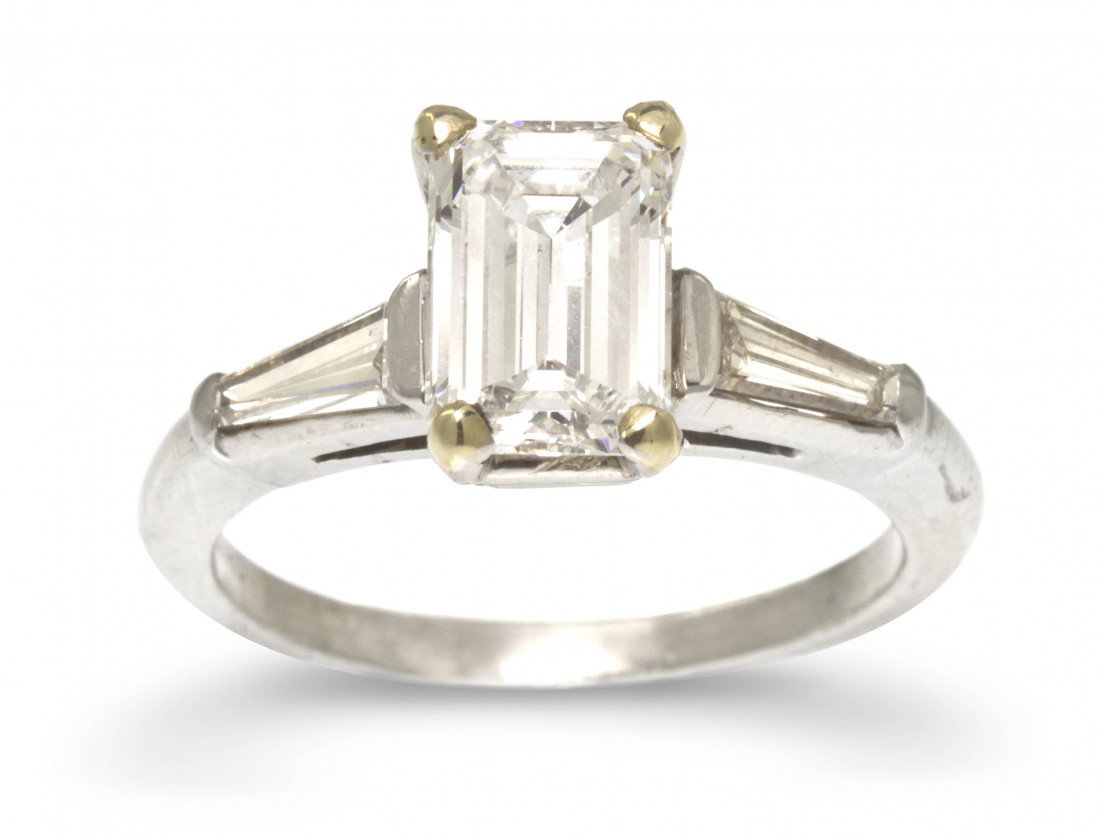 A Platinum and Diamond Ring, 3.60 dwts.: A Platinum and Diamond Ring, containing one octagonal step cut diamond weighing approximately 1.50 carat and two tapered baguette cut diamonds weighing approximately 0.40 carat total. Stamp: 900PLAT10