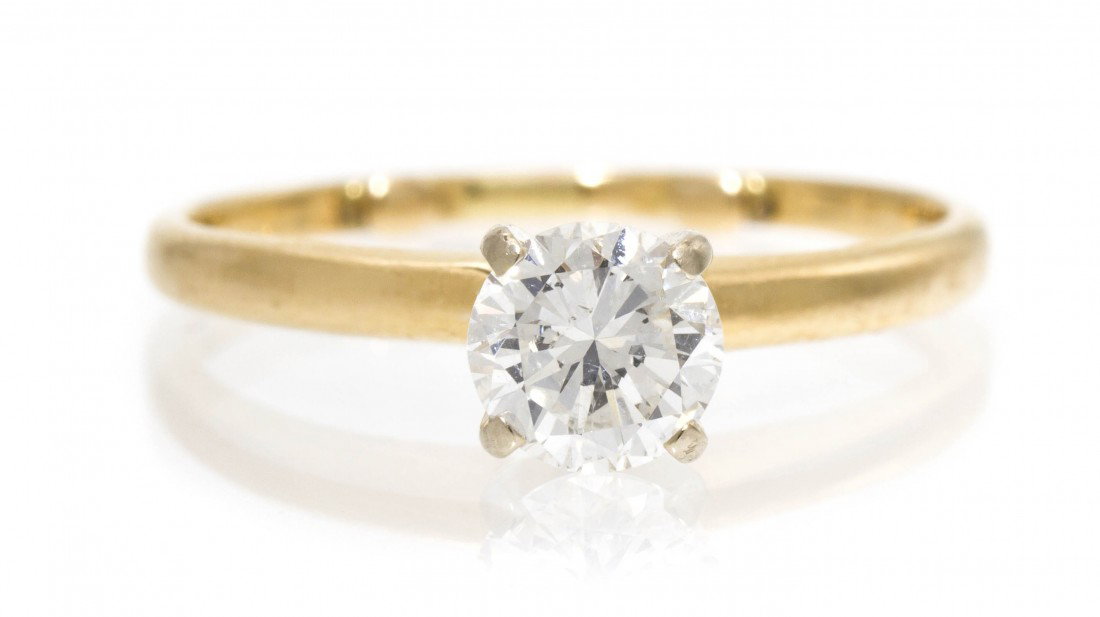 A 14 Karat Yellow Gold and Diamond Solitaire Ring,: A 14 Karat Yellow Gold and Diamond Solitaire Ring, containing one round brilliant cut diamond weighing approximately 0.70 carat. 1.30 dwts.