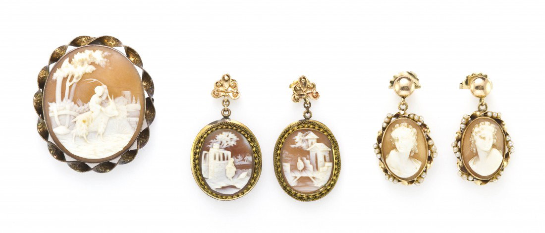 A Group of Yellow Gold and Shell Cameo Jewelry, 13: A Group of Yellow Gold and Shell Cameo Jewelry, consisting of a pendant/brooch with a scene of a boy riding a goat, a pair of earrings with town scenes and a pair of earrings with a female profile edg