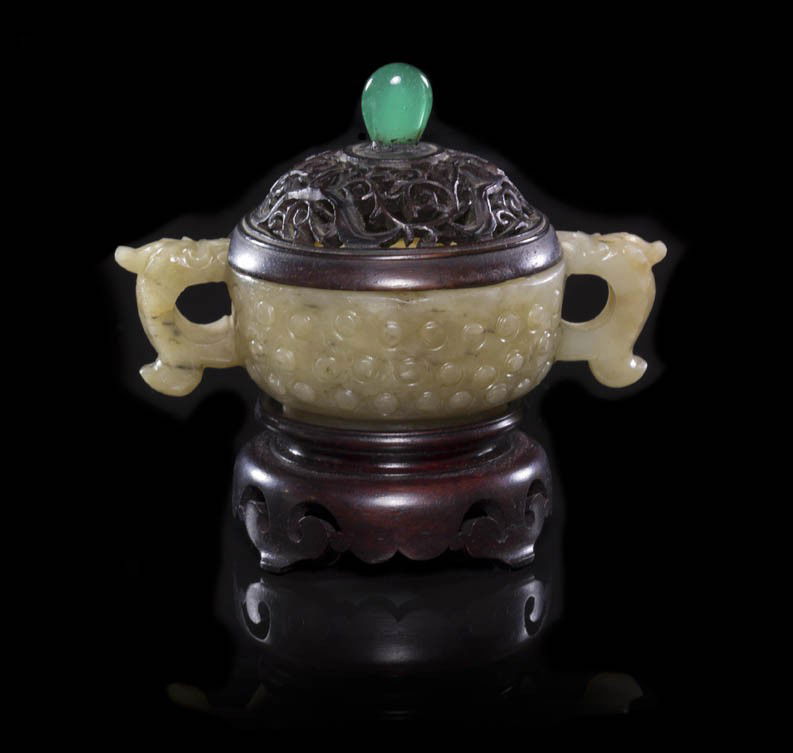 A Carved Jade Double-Handled Libation Cup, Width o: A Carved Jade Double-Handled Libation Cup, late Ming/early Qing, of near white and tan colored stone, having double c-form handles in the shape of beasts with the body carved with raised bosses throug