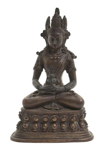 A Southeast Asian Bronze Figure of a Deity, Height: A Southeast Asian Bronze Figure of a Deity, depicted seated with elaborate headdress, elongated earlobes and hands clasped in a dhyana mudra, raised on a double lotus base. Height 7 7/8 inches.