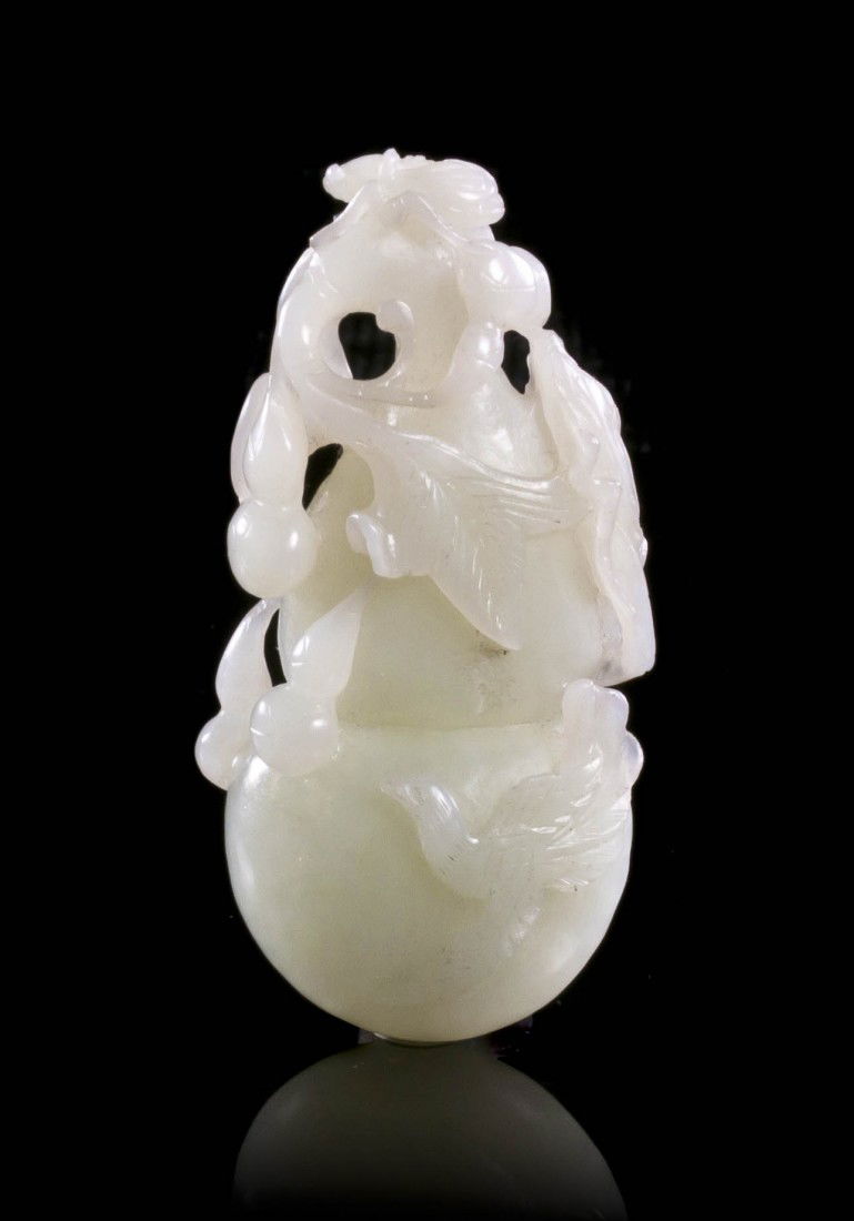 A Carved Jade Gourd Toggle, Height 2 3/4 inches.: A Carved Jade Gourd Toggle, Qing Dynasty, of an even, white stone, depicting a double gourd issuing a curved branch of scrolling leaves and tendrils and other double gourd form fruits, surmounted by a