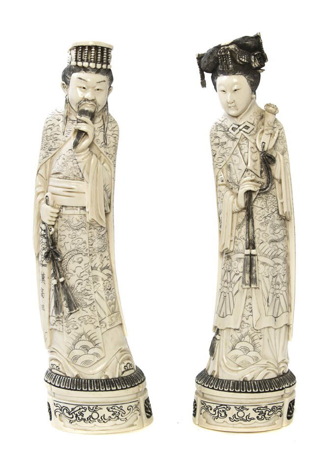 A Pair of Carved Ivory Figures, Height of tallest: A Pair of Carved Ivory Figures, the woman shown with a ruyi scepter and the man holding a sword. Height of tallest 14 3/8 inches. Property from the Collection of Dana and Heather Green, Chicago, Illin