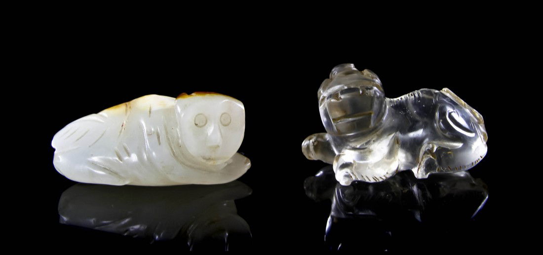 A White Jade Toggle of a Monkey, Width of first 2: A White Jade Toggle of a Monkey, of opaque white stone with russet skin behind the head and the back, together with a quartz carving of a beast. Width of first 2 inches.