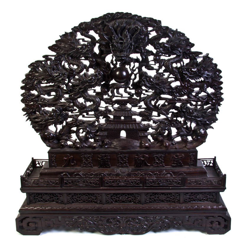 A Chinese Pierced Wood Table Screen, Height 33 x w: A Chinese Pierced Wood Table Screen, of circular form, having pierced and relief carved scene of a forward facing dragon flanked by eight others, each clutching a pearl and surrounded by scrolling clo