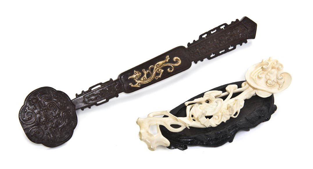 A Bone Inset Hardwood Ruyi Scepter, Length of long: A Bone Inset Hardwood Ruyi Scepter, having raised scrolling decoration throughout the head and stem with a carved bone qilong at the center of the stem, together with a carved ivory scepter. Length of