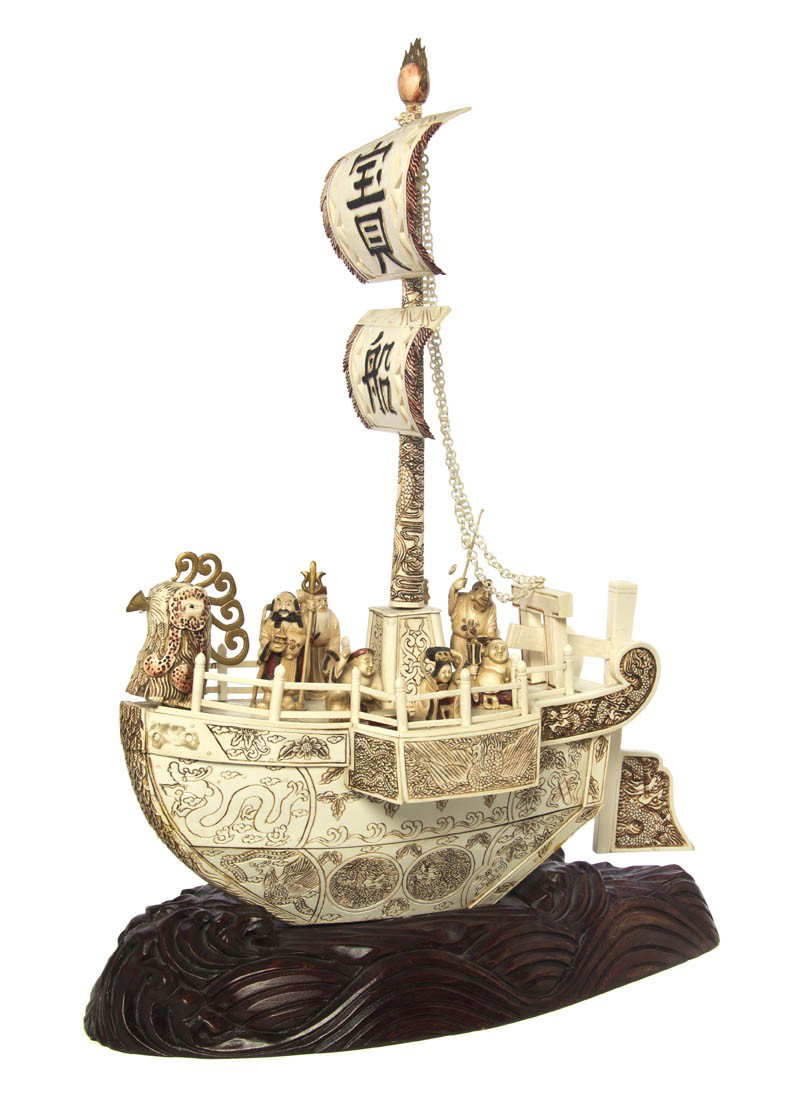 A Chinese Ivory Model of a Chicken Boat, Height of: A Chinese Ivory Model of a Chicken Boat, the single masted ship having seven figures on the deck with the ship having a chicken head at front and rudder at the back, with incised decoration throughout