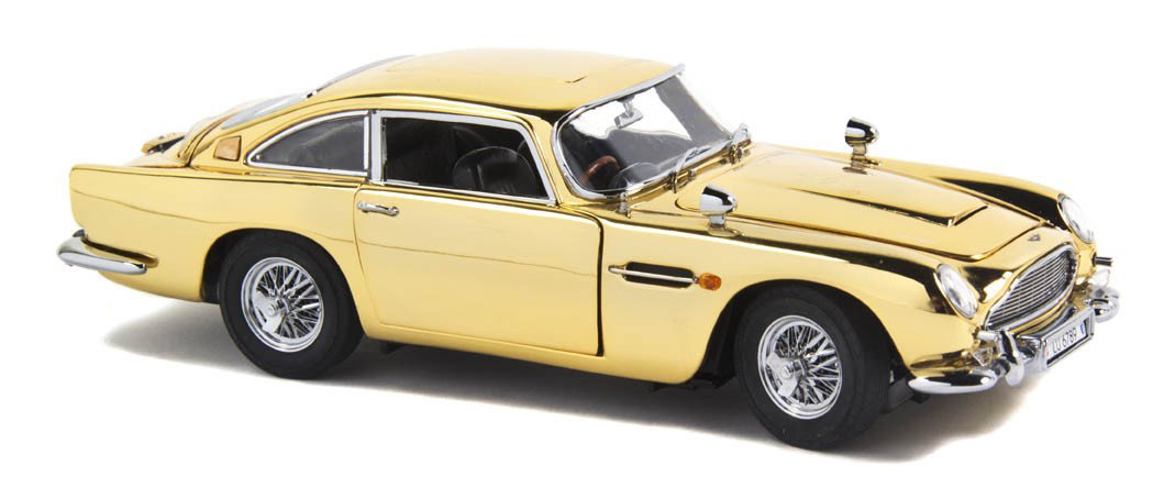 (FLEMING, IAN) DANBURY MINT ASTON MARTIN DB5. Danbu: (FLEMING, IAN) DANBURY MINT ASTON MARTIN DB5 Danbury mint 22kt Gold James Bond 007 Aston Martin DB5, gold plated issue with black interior, chrome trim, with numerous operating features. With "Certifi