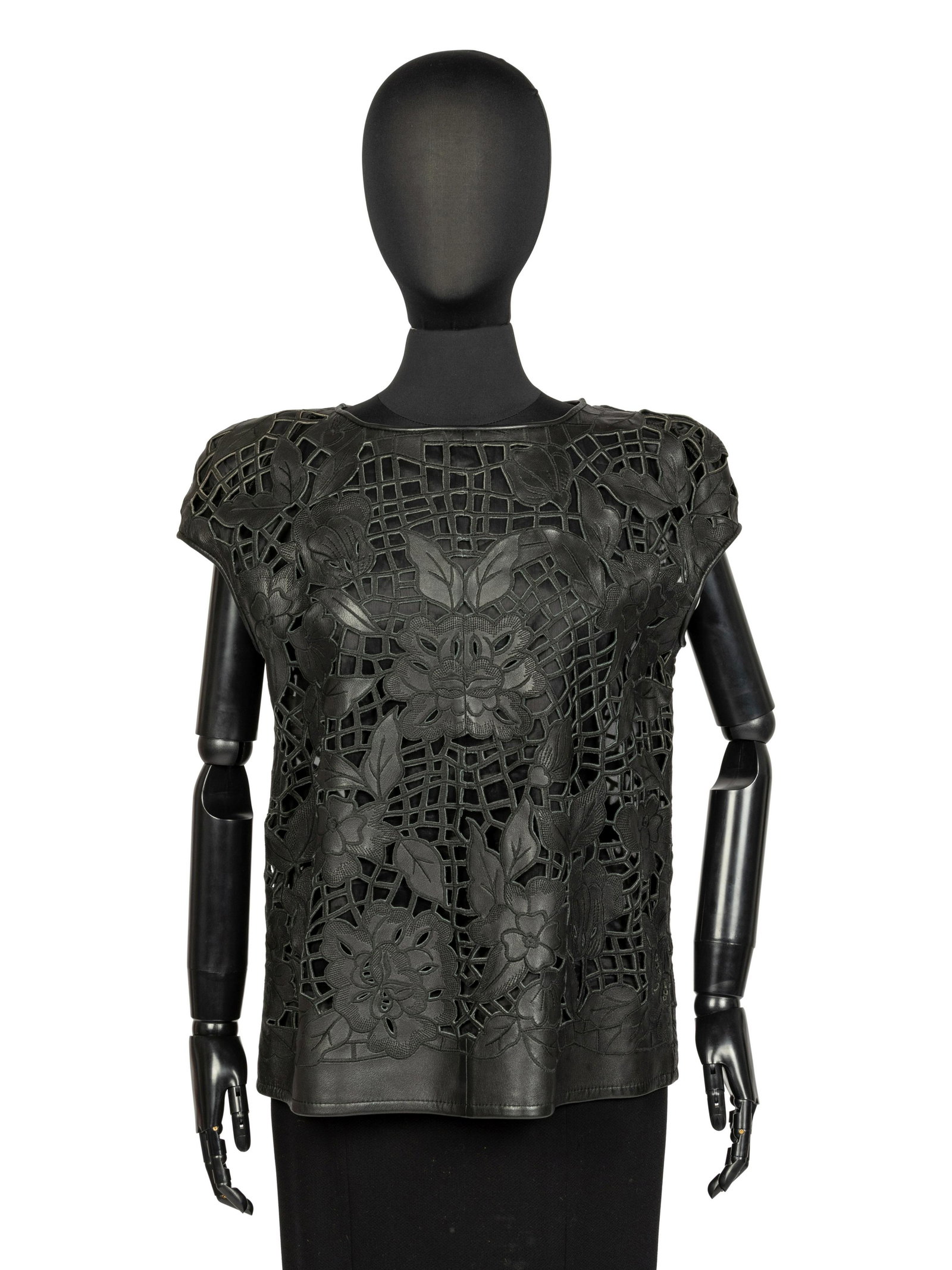 Valentino Leather Top, 1980s: Valentino Leather Top, 1980s Sleeveless black leather top with an all-over cut out design in a floral and lattice work pattern. The top is lined in a black fabric and pulls over the head with no closu