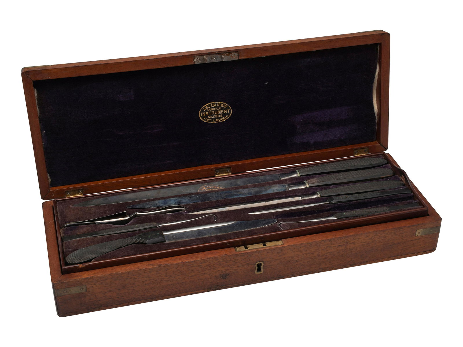 [SCIENCE & MEDICINE]. Amputation kit by A.M. Leslie & Co., St. Louis.: [SCIENCE & MEDICINE]. Amputation kit by A.M. Leslie & Co., St. Louis. Velvet-lined wooden box with brass fittings and missing cartouche, 16 1/4 x 5 3/4 x 1 3/4 in. (3 tools missing from slots; upper v