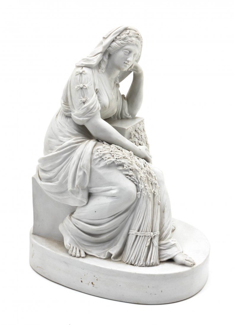 A Parian Figure of Ruth, Height 7 1/2 inches.: A Parian Figure of Ruth, depicted in a seated pose with bundles of wheat, raised on an oval base. Height 7 1/2 inches.