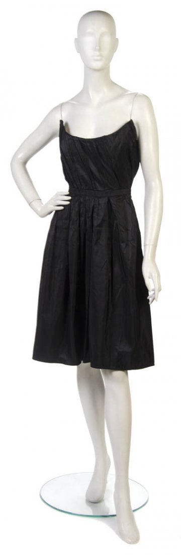 A Mila Schon Black Silk Cocktail Dress, Size 40.: A Mila Schon Black Silk Cocktail Dress, strapless with pleated detail at bodice leading into full skirt. Labeled: Mila Schon. Size 40.