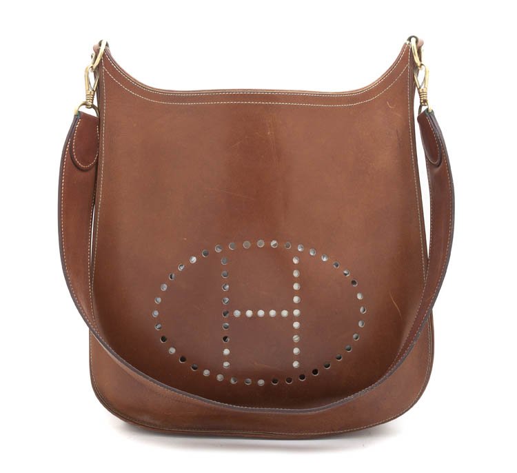 An Hermes 'Evelyne' Cognac Barrenia Calf Leather B: An Hermes 'Evelyne' Cognac Barrenia Calf Leather Bag, with both a leather and canvas interchangeable shoulder strap, named for ?velyne Bertrand, the head of the Herm?s riding department. Stamped: Herm
