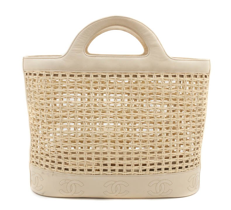 A Chanel Tan Straw and Leather Beach Tote, 16 x 13: A Chanel Tan Straw and Leather Beach Tote, together with an attached leather compartment. Stamped: Chanel. 16 x 13 inches. Property from the Collection of a Lady, Palm Beach, Florida