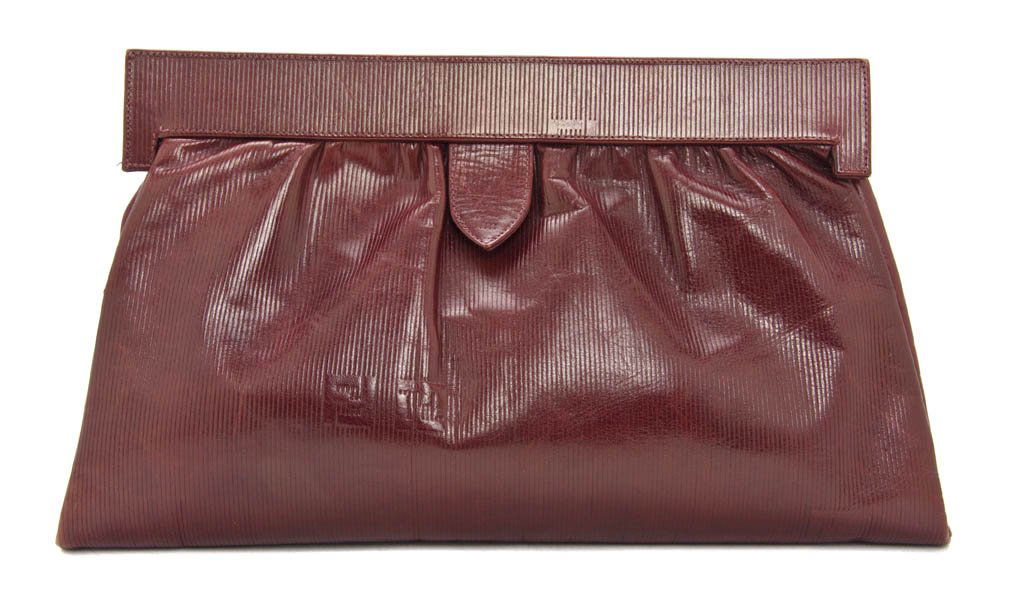A Fendi Red Leather Clutch, 15 x 9 inches.: A Fendi Red Leather Clutch, with leather shoulder strap. Stamped: Fendi. 15 x 9 inches.