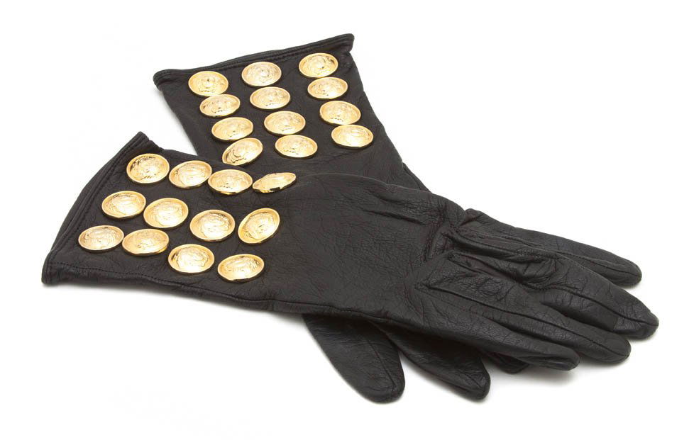 A Pair of Gianni Versace Black Leather Gloves, Siz: A Pair of Gianni Versace Black Leather Gloves, with rows of Medusa buttons. Labeled: Gianni Versace. Size M. Property from a Lady, Chicago, Illinois