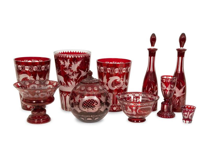 A Group of Bohemian Red Cut-to-Clear Etched Glassware: A Group of Bohemian Red Cut-to-Clear Etched Glassware 19th Century comprising a pair of large vases, a pair of decanters, another large vase, a covered ovoid jar, a stemmed goblet, a footed compote, a