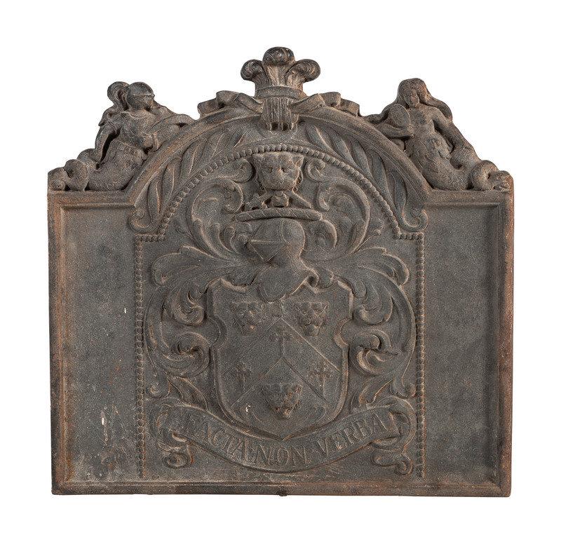 An English Cast Iron Armorial Fire Back: An English Cast Iron Armorial Fire Back 18th Century with a variation of the Fitch family crest. Height 28 1/4 x width 29 x depth 2 inches. This lot is located in Cincinnati.