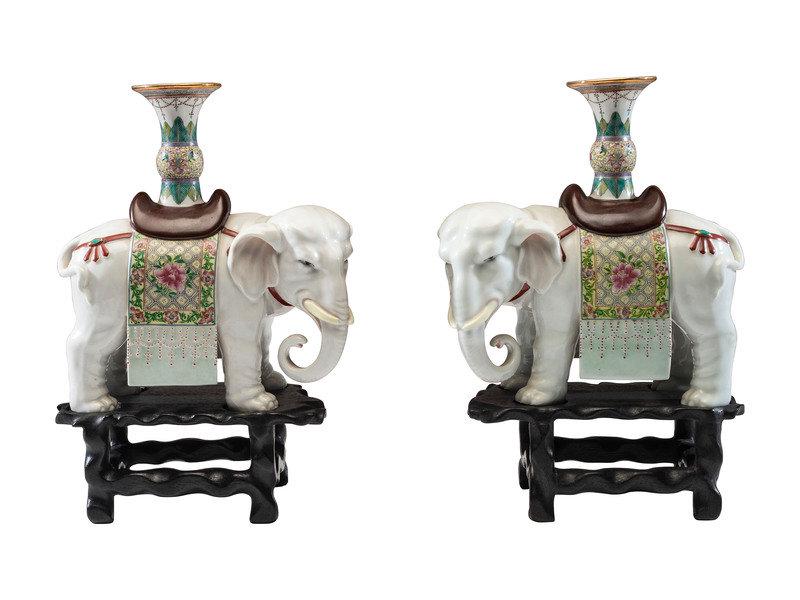 A Pair of Chinese Export Porcelain Elephant Candlesticks: A Pair of Chinese Export Porcelain Elephant Candlesticks 20th Century each with faint red stamp to underside of one foot and impressed marks to underside of howdah.with associated wood bases.
