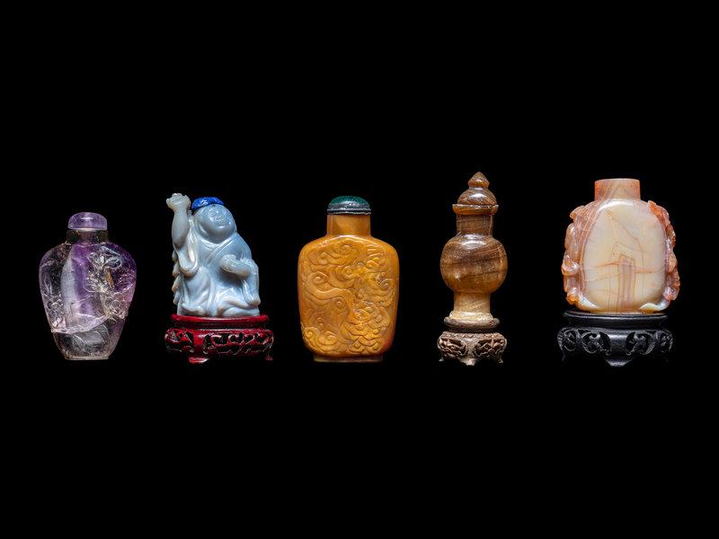 Five Chinese Carved Precious Stone Snuff Bottles: Five Chinese Carved Precious Stone Snuff Bottles Late 19th-20th Century comprising an amethyst example, a black hardstone vase-form example and three agate examples. Height of tallest 2 3/4 in., 7 cm.