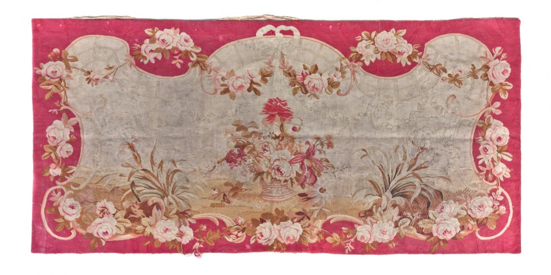 An Aubusson Wool Panel, 6 feet 2 inches x 2 feet 11: An Aubusson Wool Panel, centered with a basket of roses within a rose festoon and ribbon-tied cartouche on a red field. 6 feet 2 inches x 2 feet 11 1/2 inches.
