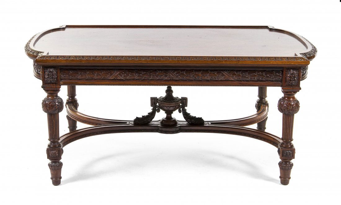 A Neoclassical Mahogany Low Table, Height 17 x wid: A Neoclassical Mahogany Low Table, having a rectangular top with rounded ends, over the foliate rosette carved frieze, raised on tapering reeded legs, joined by an X-form stretcher, centered with an u
