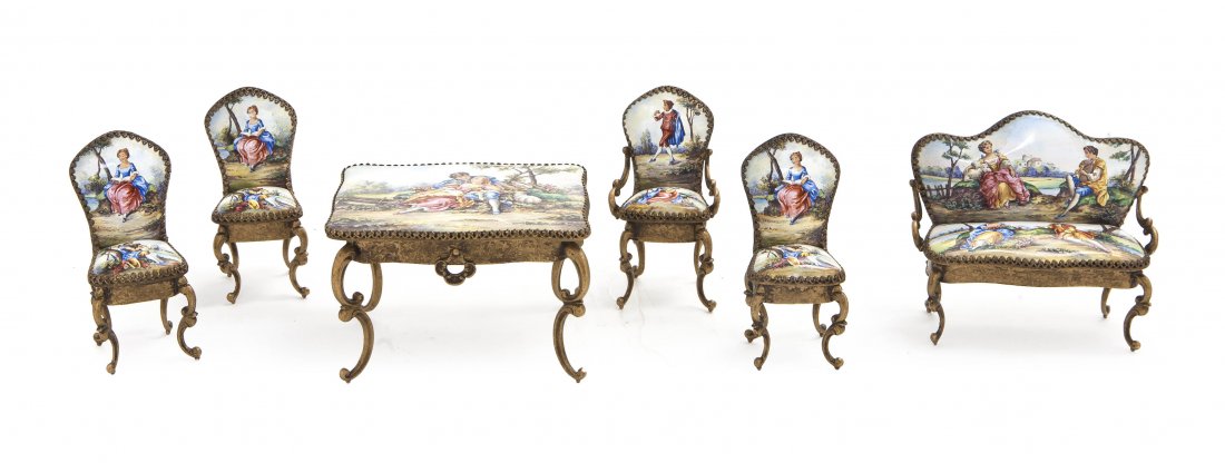 A Continental Gilt Metal and Enameled Miniature Pa: A Continental Gilt Metal and Enameled Miniature Parlor Suite, comprising a settee, an armchair, three side chairs and a table, each depicting courting couples in landscapes. Height of tallest 2 5/8 in