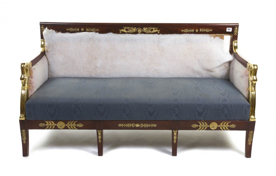 An Empire Style Mahogany and Gilt Metal Mounted Se: An Empire Style Mahogany and Gilt Metal Mounted Settee, having swan form arms enclosing an upholstered seat, raised on shaped legs ending in paw feet. Width 67 1/4 inches.