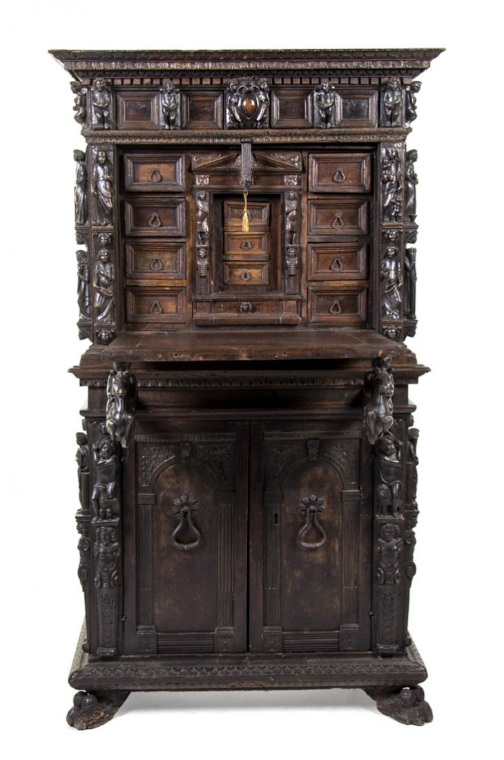 A Venetian Renaissance Revival Carved Walnut Secre: A Venetian Renaissance Revival Carved Walnut Secretaire, 17th/18th century, the superstructure having a dentiled cornice over the paneled frieze with putto mounts above a fall front door opening to a 