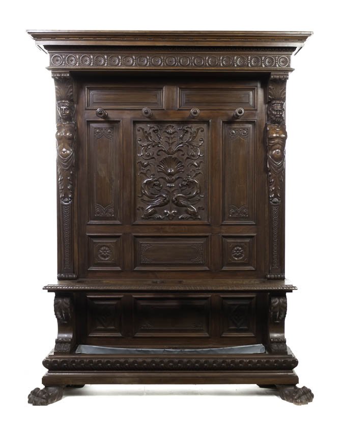 A Renaissance Revival Carved Walnut Hall Tree, Hei: A Renaissance Revival Carved Walnut Hall Tree, en suite with the preceding lot, the stepped cornice with egg and dart decoration over the paneled back with circular hooks centered with two griffins up