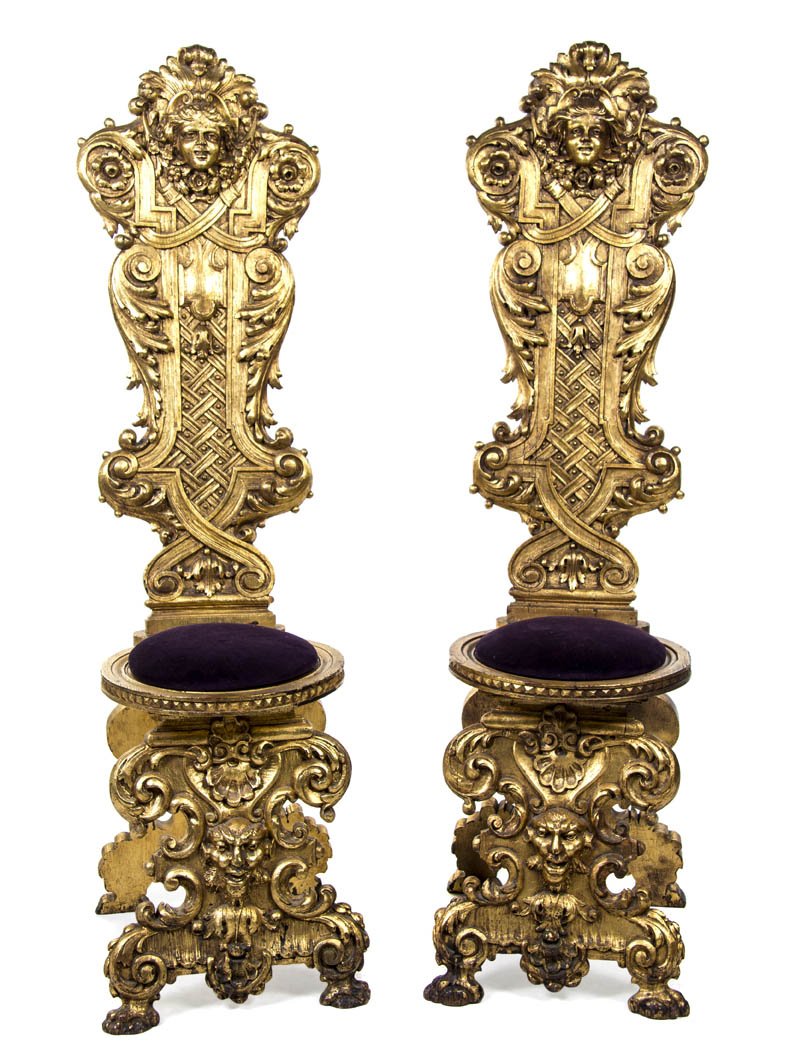 A Pair of Renaissance Revival Giltwood Hall Chairs: A Pair of Renaissance Revival Giltwood Hall Chairs, each having a foliate, mask and festoon crest over the circular upholstered seat, with lattice, grotesque mask and acanthus leaf carving throughout.