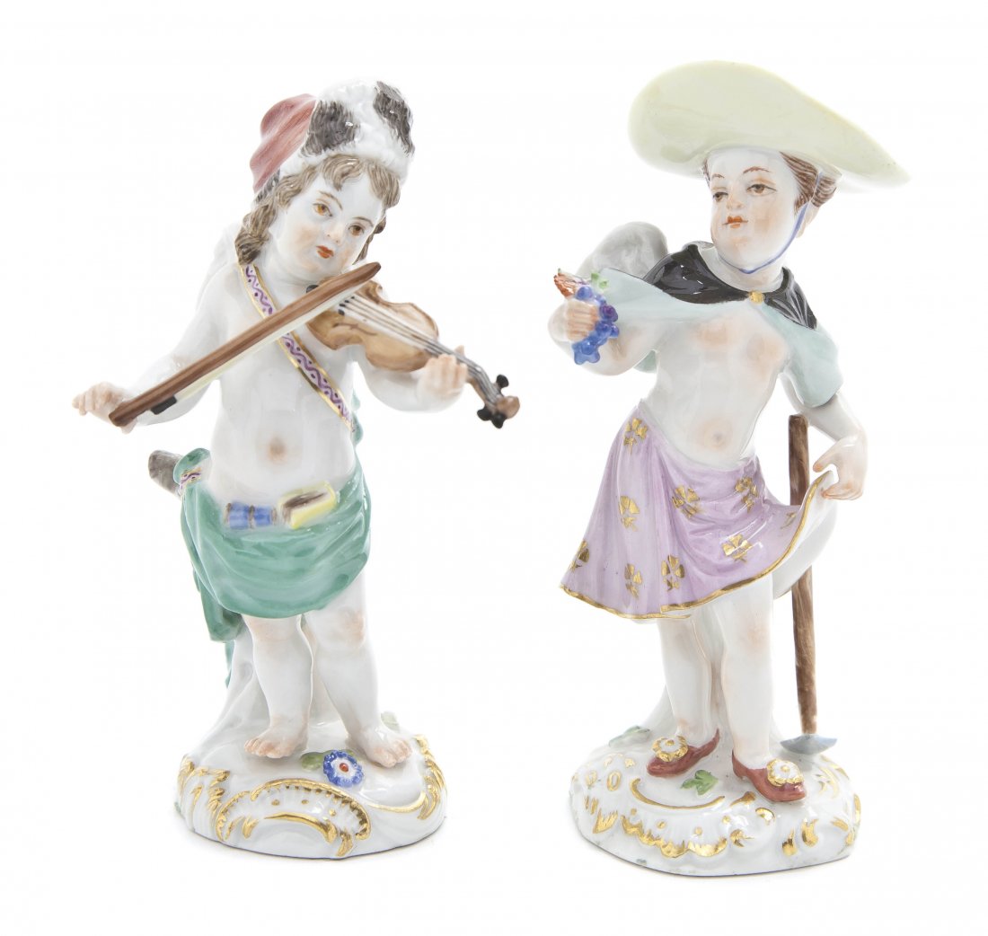 Two Meissen Porcelain Figures, Height of taller 4: Two Meissen Porcelain Figures, each depicting a putto one with a violin, the other harvesting grapes, having crossed swords in underglaze blue, having various incised and impressed marks. Height of ta