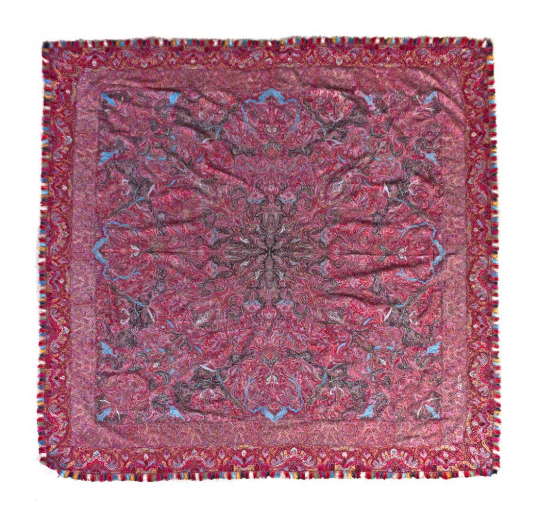 A Woven Paisley Shawl, 6 feet 2 inches x 6 feet 2: A Woven Paisley Shawl, having a central black medallion with signature and allover scrolling polychrome decoration within triple borders. 6 feet 2 inches x 6 feet 2 inches.